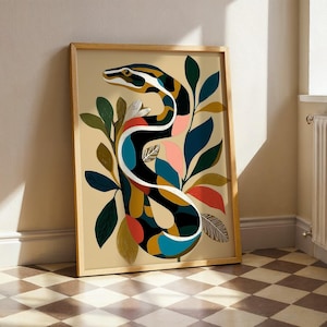 May include: A framed wall art print featuring a stylized snake with a patterned body in black, white, blue, yellow, and pink, surrounded by various abstract leaves in shades of green, gold, and red against a light beige background.