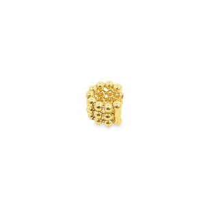 May include: A gold-colored ring composed of numerous small, spherical beads. The beads are closely arranged, forming a textured, rounded shape. The ring is set against a plain white background, highlighting its metallic sheen and intricate design.
