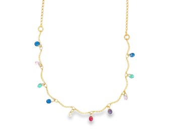 May include: A delicate gold necklace with a wavy design, adorned with small, colorful teardrop-shaped gemstones. The gemstones are in shades of blue, pink, green, and red. The necklace is displayed against a white background.