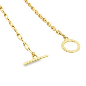 May include: A gold chain necklace with a toggle clasp and a circular ring at the end.