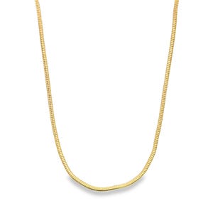 May include: A gold-colored snake chain necklace. The chain has a smooth, flexible design, and it is displayed against a white background. The necklace is a classic jewelry piece.
