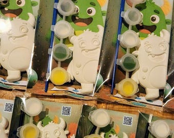 May include: Paint your own monster kit. Each kit includes a white monster figurine, paint pots in various colours, and a paintbrush. The packaging features a green monster illustration with the text "Paint Your Own Monster Kit".