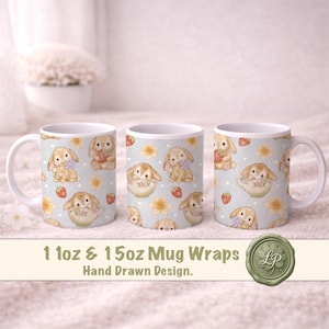 May include: Three white ceramic mugs with a repeating pattern of bunnies, strawberries, and flowers on a light blue background. The mugs are labeled "11oz & 15oz Mug Wraps" and "Hand Drawn Design."