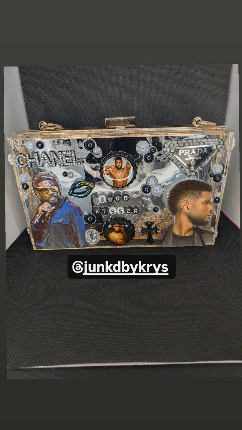 May include: A clear acrylic clutch decorated with images of celebrities, bottle caps, and rhinestones. The clutch features the text "CHANEL", "PRADA", and "GOOD KISSER". The Instagram handle "@junkdbykrys" is also visible.