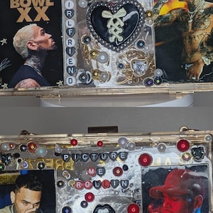 May include: A gold-framed clutch with images of a singer, embellished with beads, sequins, and text. The top section reads "BREEZY" and "BREEZY BOWL XX". The bottom section has the text "PICTURE ME ROLLIN".