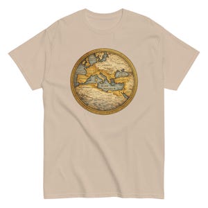 May include: A beige t-shirt with a circular map design. The map, in shades of brown, blue, and gold, shows ancient territories and is labelled with text, including "Mare Nostrum". The t-shirt is made of a soft material.