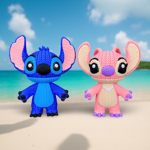 May include: Two knitted figurines of cartoon characters, one blue and one pink, stand on a sandy beach. The blue character has large ears with pink insides, and the pink character has beige insides. Both have large black eyes and are in a standing pose.