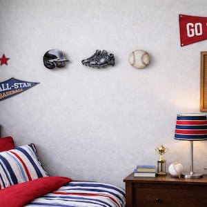 May include: A bedroom wall featuring a baseball helmet, cleats, and baseball wall decor, a red Go Team pennant, a blue All-Star Baseball pennant, a red star, a striped lamp, a gold trophy, a baseball, a leather glove, and a cork bulletin board.