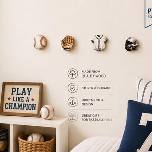 May include: Four wall-mounted hooks shaped like a baseball, a glove, a jersey, and a helmet. Text on the wall includes "PERFECT FOR ANY SPACE," "MADE FROM QUALITY WOOD," "STURDY & DURABLE," "HIDDEN HOOK DESIGN," and "GREAT GIFT FOR BASEBALL FANS."