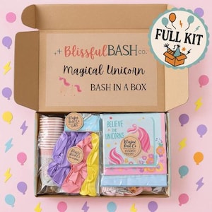 May include: A cardboard box labeled "Magical Unicorn BASH IN A BOX" with party supplies. The box contains pink, purple, and yellow balloons, cups, napkins, and other party decorations. A "FULL KIT" sticker is on the box.