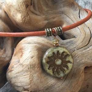 Czech picasso matte olive colored glass sun boho leather necklace, gold wash sun symbol, men or women choose your length and cord color