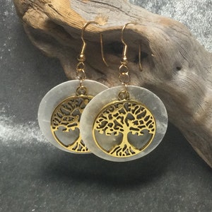 May include: A pair of gold tree of life earrings with white mother of pearl round discs.
