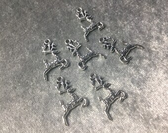 May include: A set of seven silver reindeer charms with intricate details. The charms are perfect for adding a festive touch to jewelry, crafts, or home decor.