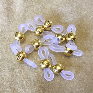 Eyeglass holders, sets in 10 piece increments, eyeglass chain holders, eyeglass grip components, white color rubber with gold bead
