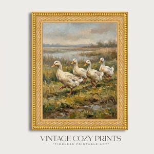 May include: A framed vintage print depicts a pastoral scene with ducks walking through a marshy area. The artwork features a gold ornate frame and a muted color palette of greens, browns, and blues. The text "VINTAGE COZY PRINTS" is at the bottom.