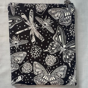 May include: Black zippered pouch with a white insect and star pattern. The design includes butterflies, dragonflies, bees, and ladybugs. The pouch has a silver zipper pull.