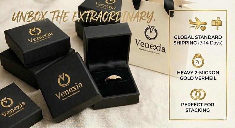 May include: Black jewelry boxes with gold lettering and a ring displayed in an open box. The text "UNBOX THE EXTRAORDINARY" is visible. A shopping bag and a graphic with text about gold vermeil are also in the image. The brand name is Venexia.