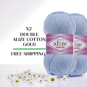 May include: Two light blue Alize Cotton Gold yarn skeins. Each skein has a pink label with the brand name. The image also includes the text "X2 DOUBLE ALIZE COTTON GOLD".
