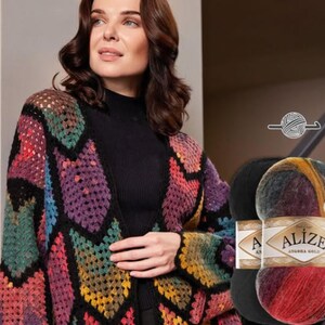 May include: A colorful, open-front crochet cardigan in a geometric pattern, featuring shades of purple, green, yellow, and red. The image also shows two skeins of Alize Angora Gold yarn, one black and one multicolored.