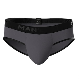 May include: Gray briefs with a black waistband featuring the word "MAN" in bold letters. The briefs have a contoured pouch and black trim along the edges. The garment is made of a soft, stretchy material.