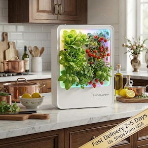 May include: A white indoor garden system with a variety of plants, including lettuce, tomatoes, and herbs. The system has a built-in LED light and the text "Linné Garden". The garden is placed on a kitchen countertop.