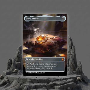 May include: A Mox Amber card featuring a large, amber-colored gem with a silver chain resting on a velvet pillow. The card is labeled "Legendary Artifact" and includes text about mana and planeswalkers.
