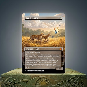 May include: A collectible trading card titled Ocelot Pride featuring an illustration of two adult ocelots and two kittens in a golden grassy field. The sky contains cloud formations shaped like cats and colorful butterflies. Text details game rules.
