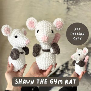 May include: Three white crochet mice with pink ears and noses, and dark brown weights. The mice are holding weights and have black eyes. The text "SHAUN THE GYM RAT" is at the bottom of the image, and "PDF PATTERN ONLY" is in a circle.