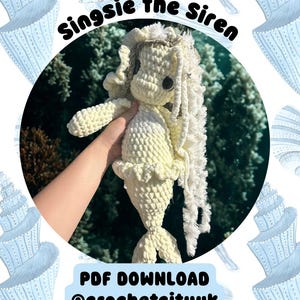 May include: A handmade crochet mermaid doll in cream and white, with long, flowing hair and a ruffled tail. The doll is held in front of a blurred underwater background. Text on the image reads "Singsie the Siren" and "PDF DOWNLOAD @crochetcityuk."