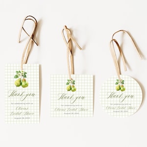 May include: Three gift tags with a pear illustration and the text "Thank you". The tags are rectangular, square, and circular, with a light green gingham pattern. Each tag has a brown string for hanging.