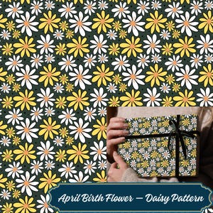 May include: A gift box wrapped in daisy-patterned paper, featuring white and yellow flowers on a dark green background. The box is tied with a black ribbon. The text "April Birth Flower - Daisy Pattern" is at the bottom.