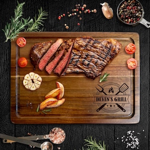 May include: A wooden serving board with a grilled steak, sliced to show the pink inside. Garnishes include tomatoes, garlic, and potato wedges. The board is branded with "Deven's Grill".
