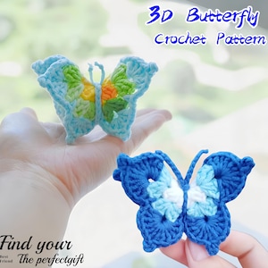 May include: Two crocheted butterfly patterns in the image. One butterfly is held in a hand, featuring light blue, green, yellow, and orange colors. The other butterfly is blue and white. Text in the image reads "3D Butterfly Crochet Pattern" and "Find your The perfect gift".