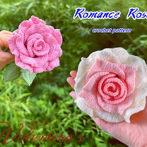 May include: Two handmade crochet roses, one pink and one white and pink, are displayed against a green background. The pink rose is held by a hand, while the other rests in a palm. Text reads "Romance Rose crochet pattern" and "Gift for Valentine's".