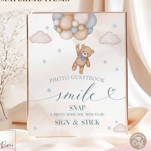 May include: A baby shower sign featuring a teddy bear with balloons. The sign has the text "Photo Guestbook, Smile, Snap, Sign & Stick." The design includes blue stars and clouds. The text "Search: 05V2 for matching items" is also visible.