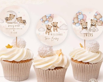 May include: Three cupcakes with white frosting and decorative toppers. The toppers feature teddy bears and text that reads "Thank you beary much", "Welcome Twin Baby", and "Hello Twins". The image includes the text "SEARCH: 05T3 FOR MATCHING ITEMS".