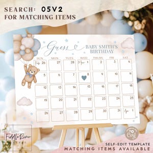 May include: A baby shower calendar with a teddy bear holding balloons. The calendar has a light blue and beige color scheme with the text "Guess Baby Smith's Birthday". The calendar is on a wooden easel.