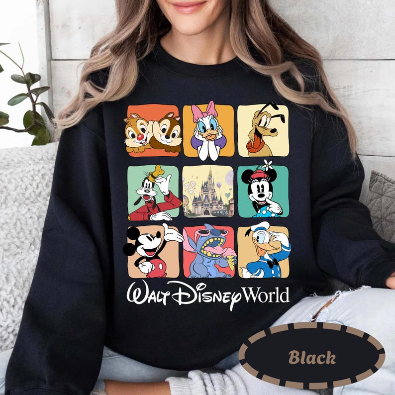 May include: Black sweatshirt featuring a grid of Disney characters including Chip and Dale, Daisy Duck, Pluto, Goofy, Mickey Mouse, Stitch, and Donald Duck. The words "Walt Disney World" are printed below the grid in white script.