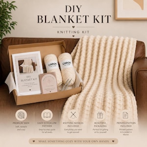 May include: A DIY blanket knitting kit in a cardboard box containing two skeins of cream-colored Caron One Pound yarn, a pair of knitting needles, and a printed instruction guide. A finished cream-colored knitted blanket is draped nearby.