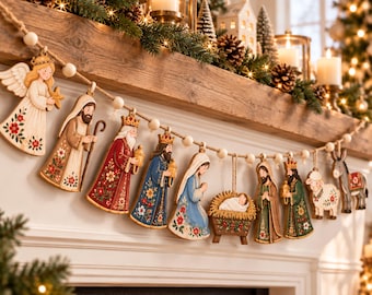 Pode incluir: Uma guirlanda decorativa com recortes de madeira de um presépio, incluindo um anjo, pastores, reis magos, Maria, José, o menino Jesus na manjedoura, uma ovelha e um burro, todos unidos por contas de madeira de cor clara.