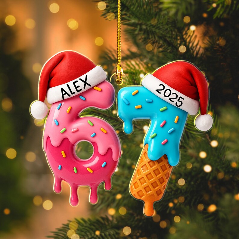 May include: Two Christmas ornaments shaped like the numbers 6 and 7, with Santa hats. The number 6 is pink with sprinkles and the name "ALEX". The number 7 is blue with sprinkles and the year "2025".