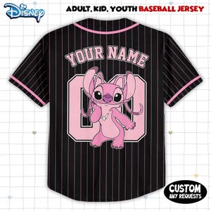 May include: Black baseball jersey with pink pinstripes, featuring a pink cartoon character and the text "YOUR NAME" above a number. The jersey has pink accents and the Disney logo.