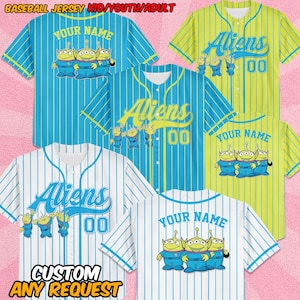 May include: Baseball jerseys in various colors, including blue, white, and yellow, with vertical stripes. Each jersey features the word "Aliens" or "Your Name" and cartoon alien graphics. The text "CUSTOM ANY REQUEST" is also visible.