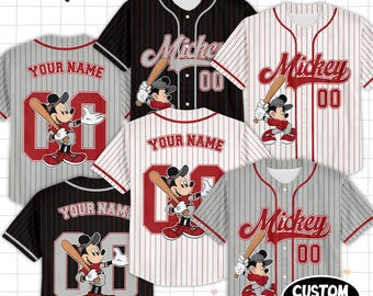 May include: Baseball jerseys featuring Mickey Mouse designs. The jerseys come in various colors, including black, white, and gray, with red accents. Each jersey displays the name "Mickey" or "Your Name" and the number "00".