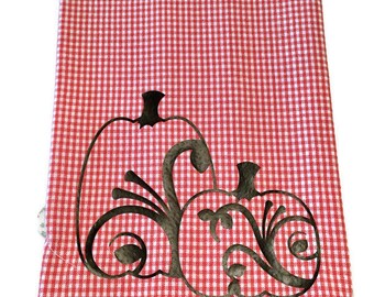 Black vinyl iron on pumpkins on a white and orange checked dish towel