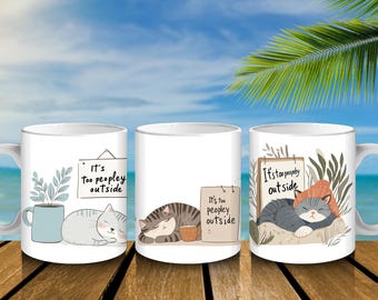 May include: Three white ceramic mugs with cat illustrations and the text "It's too peopley outside." One mug shows a gray cat with a sign and a plant. Another shows a tabby cat with a cup. The third shows a gray cat with a hat.