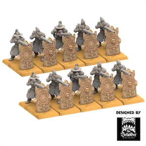 Puede incluir: Figuras en miniatura de soldados con rifles y escudos. Los soldados están en posición de disparo, detrás de escudos ornamentados con un emblema central. Las figuras están sobre bases individuales, dispuestas en filas. Diseño de The Beholder Miniatures.