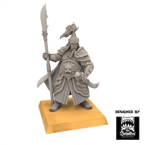 May include: A grey miniature warrior figure in detailed armour, holding a spear. The figure stands on a small, tan base. The warrior has a detailed helmet and a decorative belt buckle. The image includes the text "DESIGNED BY" and a logo.