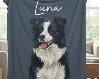 May include: A navy blue blanket with a painted portrait of a black and white Border Collie dog and the name "Luna" in white script. The dog has a pink tongue. The background is a solid colour.
