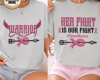 May include: A light gray t-shirt featuring the word WARRIOR in pink with wings and an arrow wrapped in a pink ribbon. A second light gray t-shirt displays the text HER FIGHT IS OUR FIGHT, #TeamMonica, and an arrow with a pink ribbon.